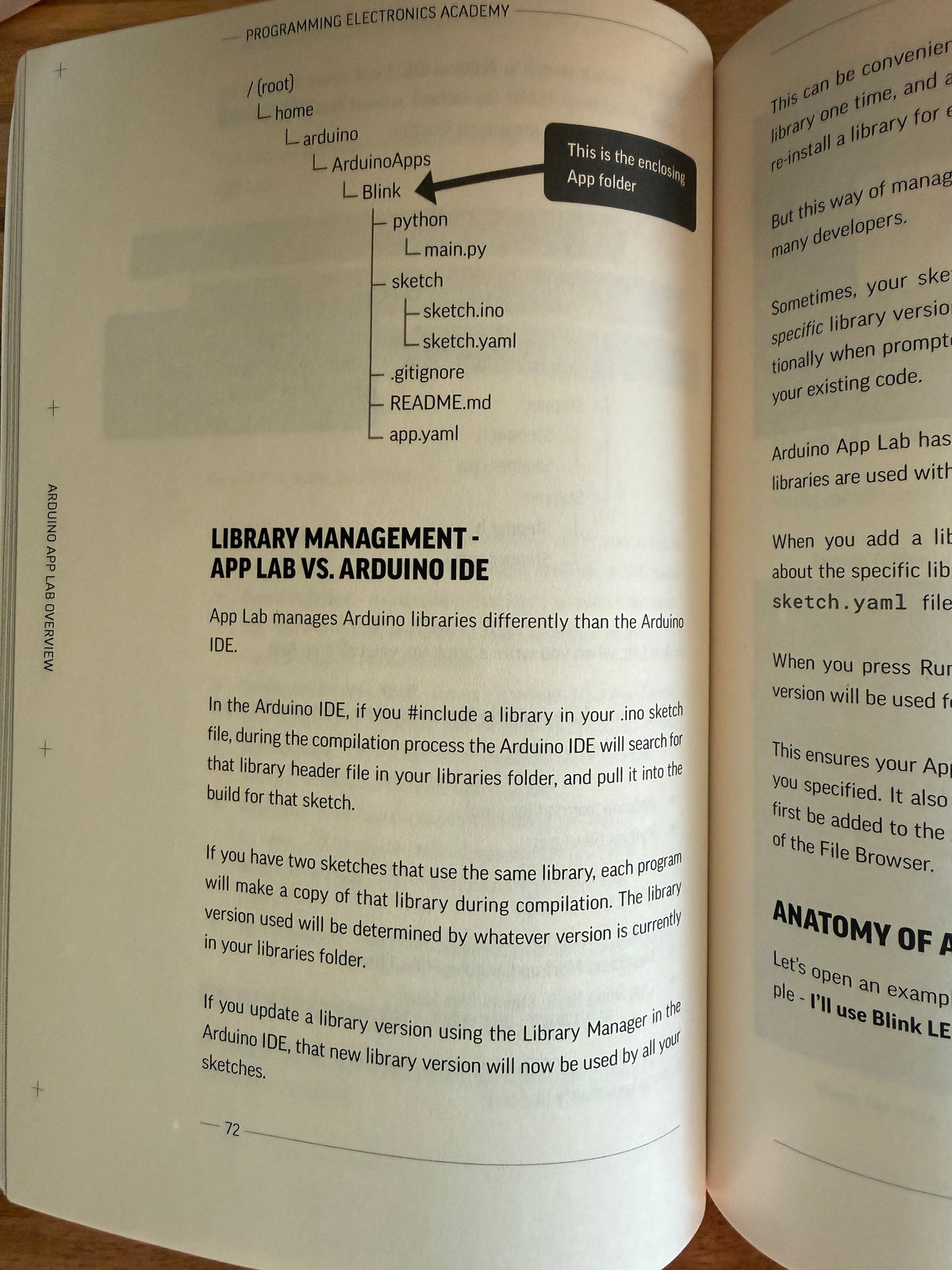 An open book showing printed pages with text and a small bar chart related to library management and Android IDE. The book is photographed on a wooden surface.